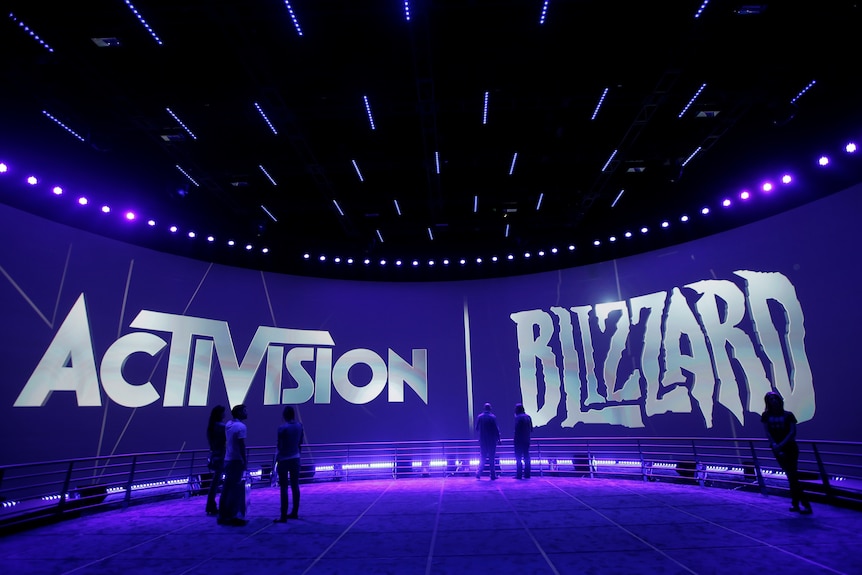 Large Activision and Blizzard logos are brandished on the rounded sides of a large room lit in purple