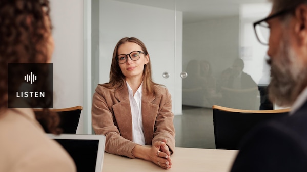 A woman sits for a job interview. Has Audio.
