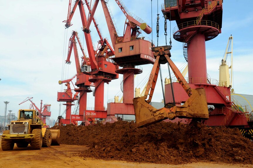Iron ores are unloaded at a port in Lianyungang,
