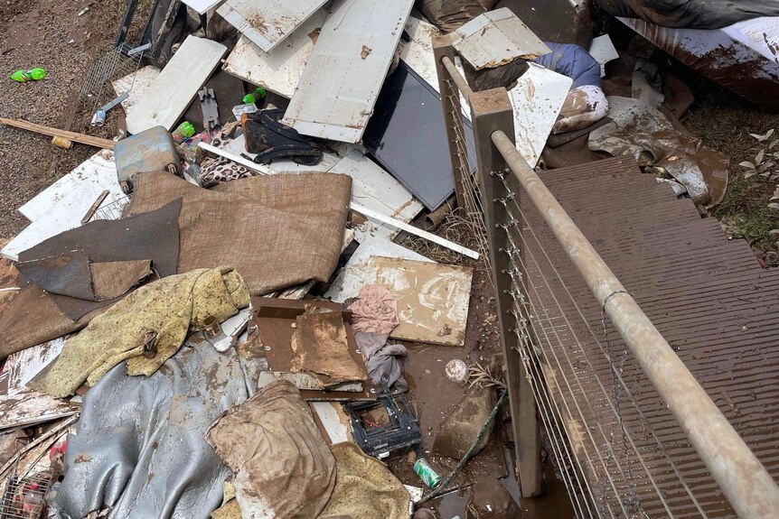 A pile of flood damaged house items and belongings.