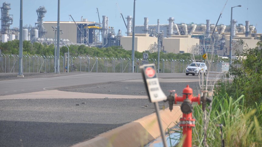 A car drives past the outside of the gas plant