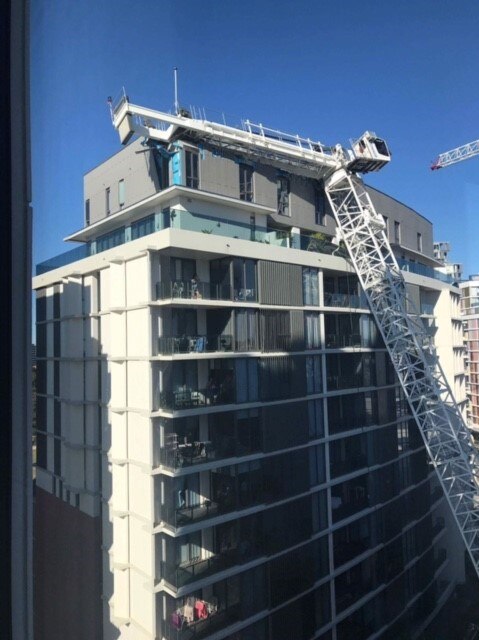 Crane falls on apartment block