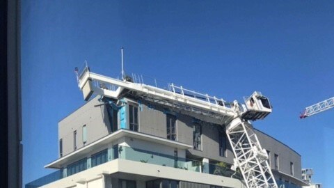 Crane falls on apartment block