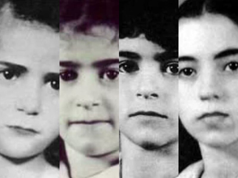 A close up of four children in black and white.