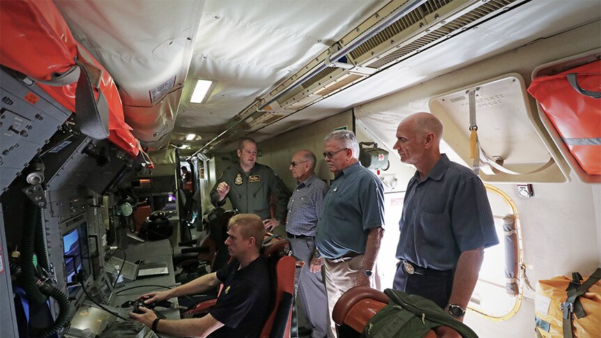 Air Force veterans get a tour inside an AP-3C Orion aircraft