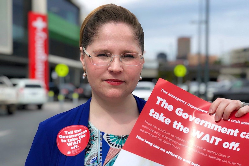 Elizabeth Dabars holding a poster outside the RAH