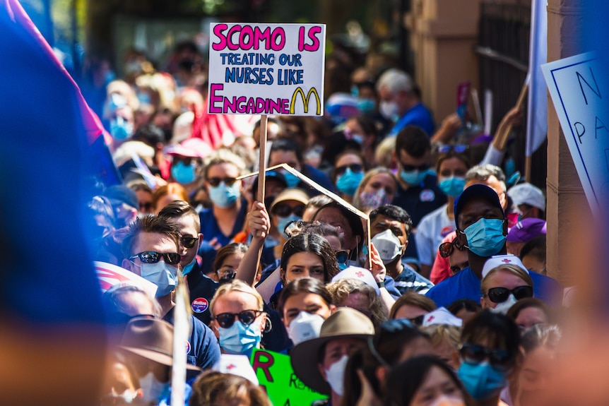 Protesting nurses holding signs