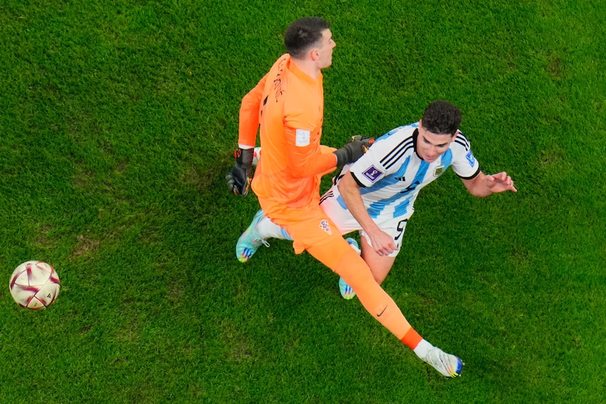 Croatia goalkeeper Dominik Livakovic takes down Julian Alvarez in the FIFA World Cup semifinal between Argentina and Croatia.