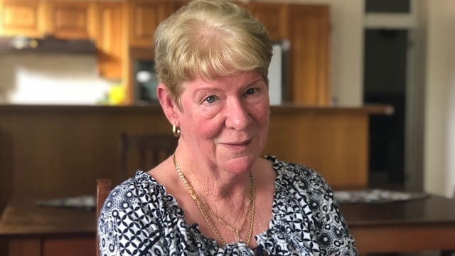 A woman sits at a table