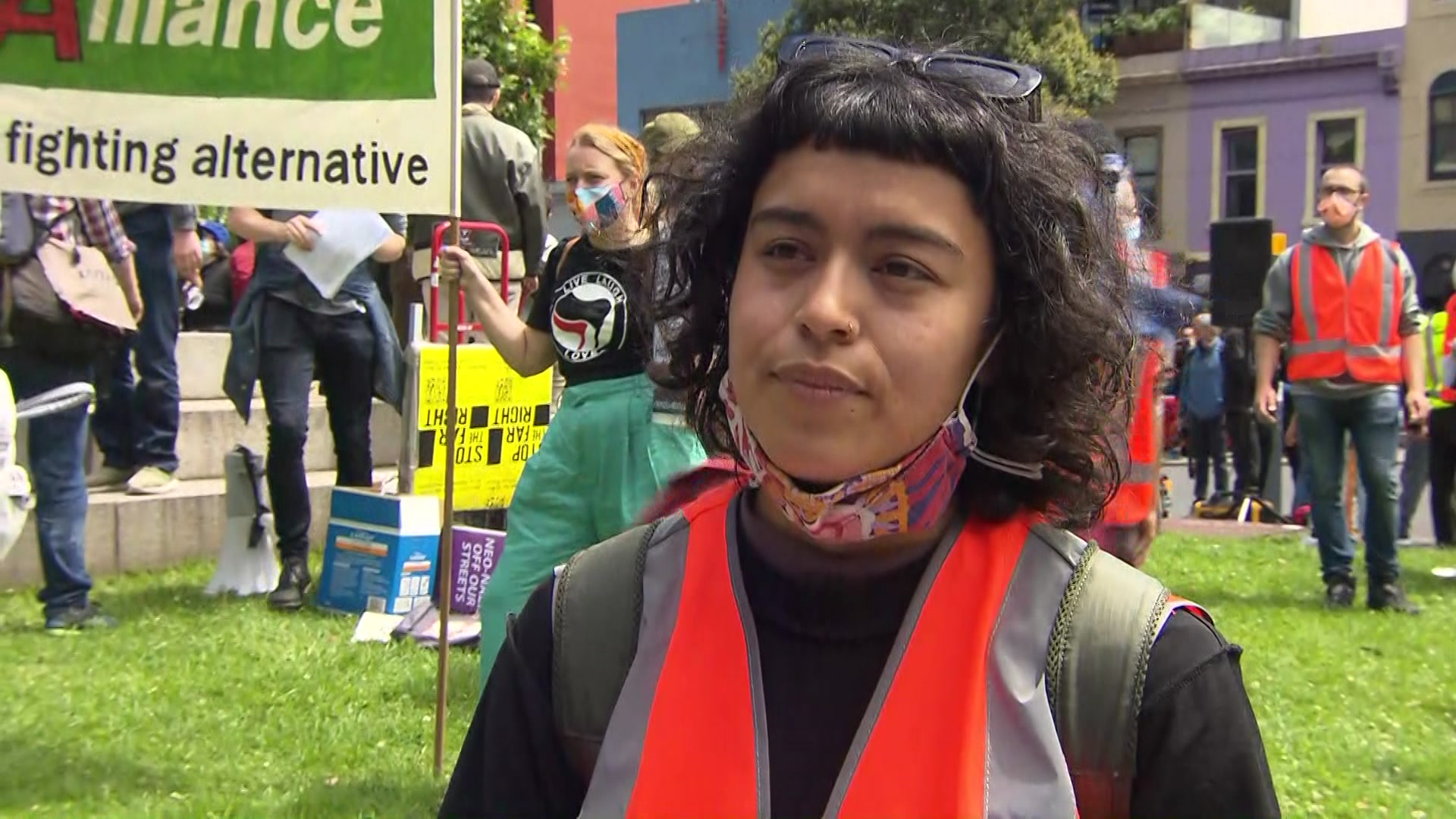 A woman in a flourescent vest at a protest