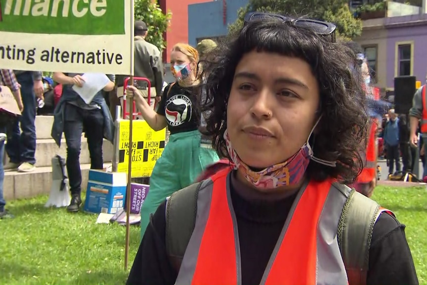 A woman in a flourescent vest at a protest