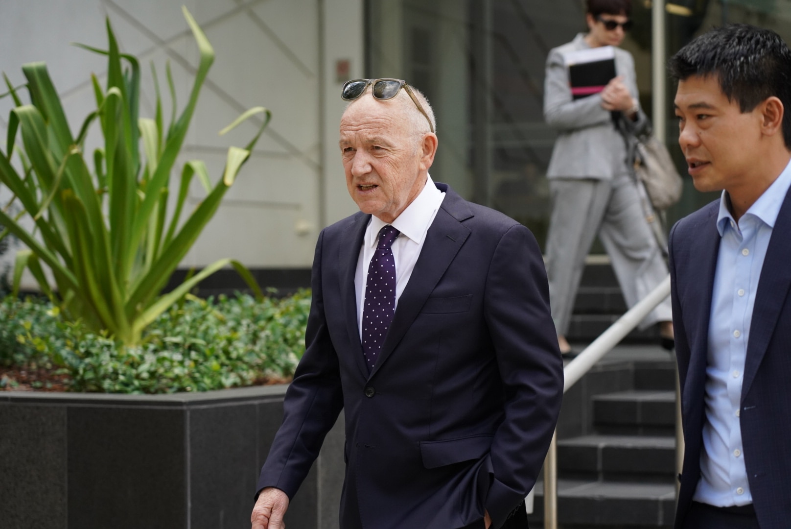 Um homem de terno desce as escadas de um tribunal em Perth 