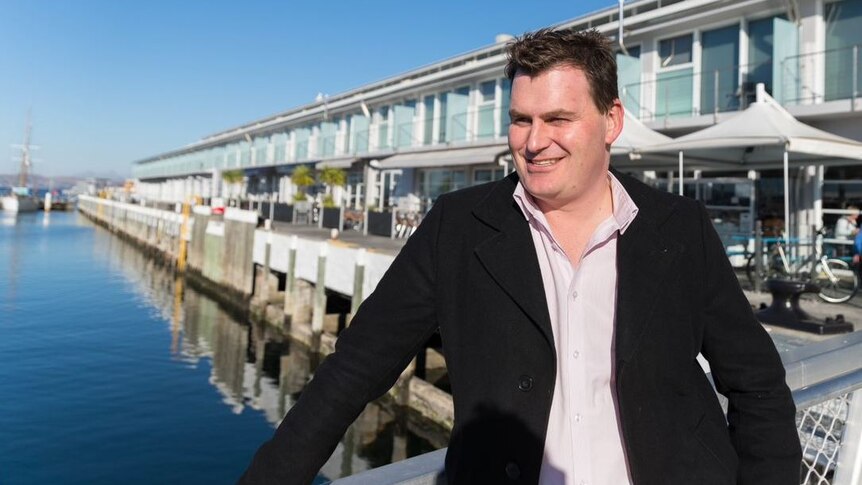 Luke Martin from Tasmanian Tourism Council stands on Tasmania's wharves.