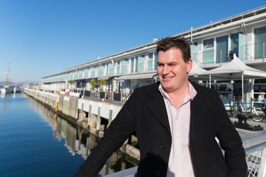 Luke Martin from Tasmanian Tourism Council stands on Tasmania's wharves.