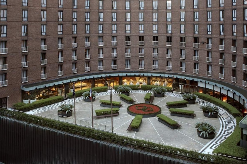 the exterior of a hotel with a garden and restaurant