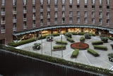 the exterior of a hotel with a garden and restaurant