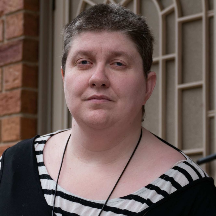 Leah Van Poppel stands outside her front door.