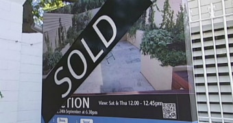 Real estate board with Sold sign