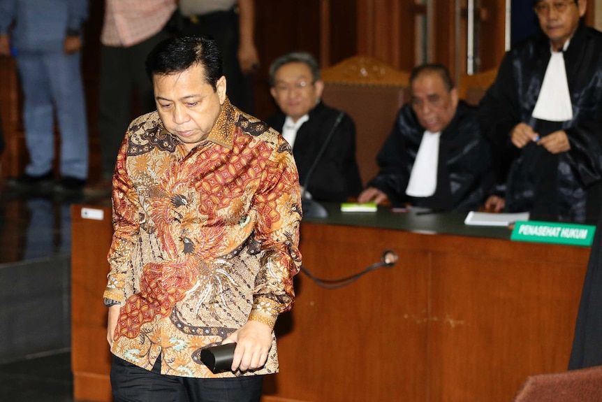 Setya Novanto in a court room looking downwards.