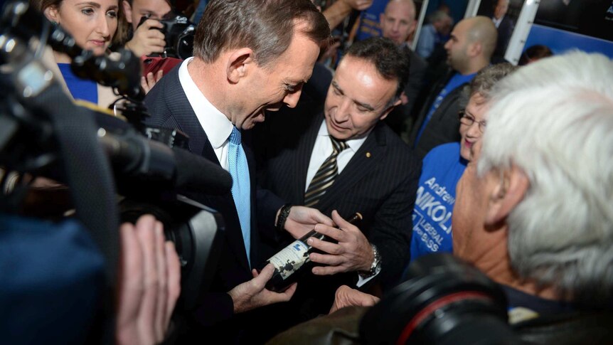Tony Abbott (left) and Andrew Nikolic hold a bottle of 1984 Liberal Party tawny port