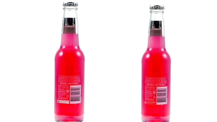 Two bottles of brightly coloured drinks and their labels.