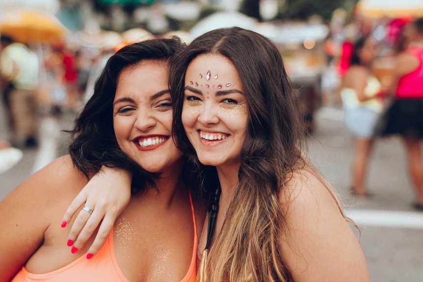 Two women hug and smile