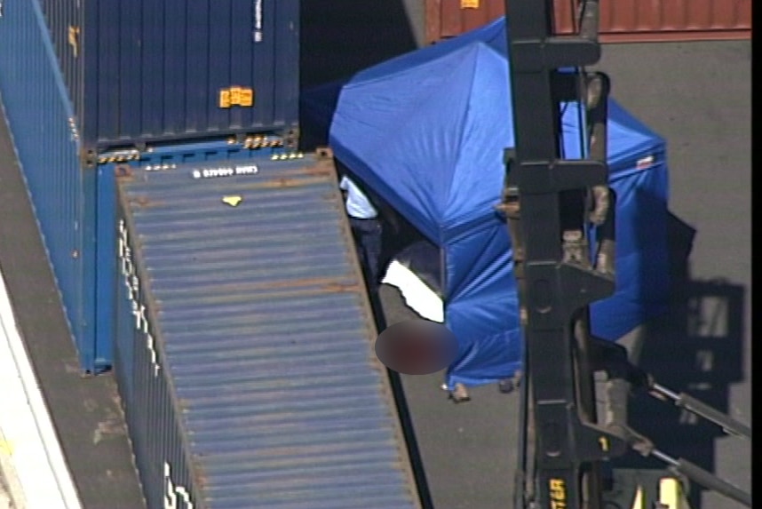 aerial vision of a tent next to a pool of blood and a container
