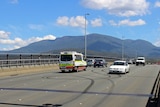 An ambulance passes burnout marks on the Tasman Bridge