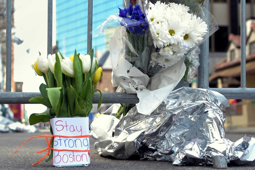 Flowers mark the spot where two bombs went off during the Boston Marathon in 2013, killing three people.