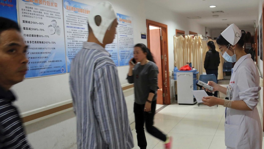 A brain surgery patient walks down the corridor of Ruijin Hospital's neurosurgery centre.