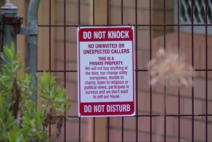 A sign that warns people not to disturb the occupants of a home.