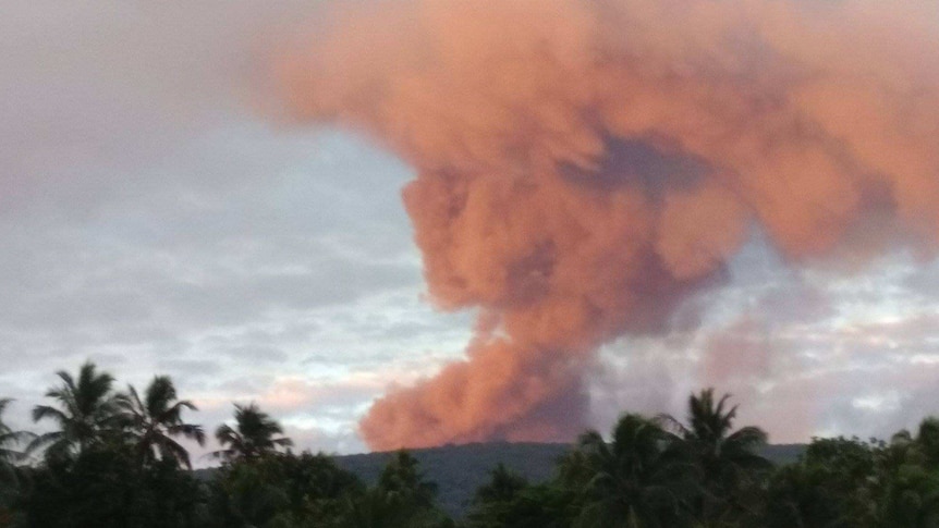 Manaro volcano on Ambae island in Vanuatu with red smoke coming out.