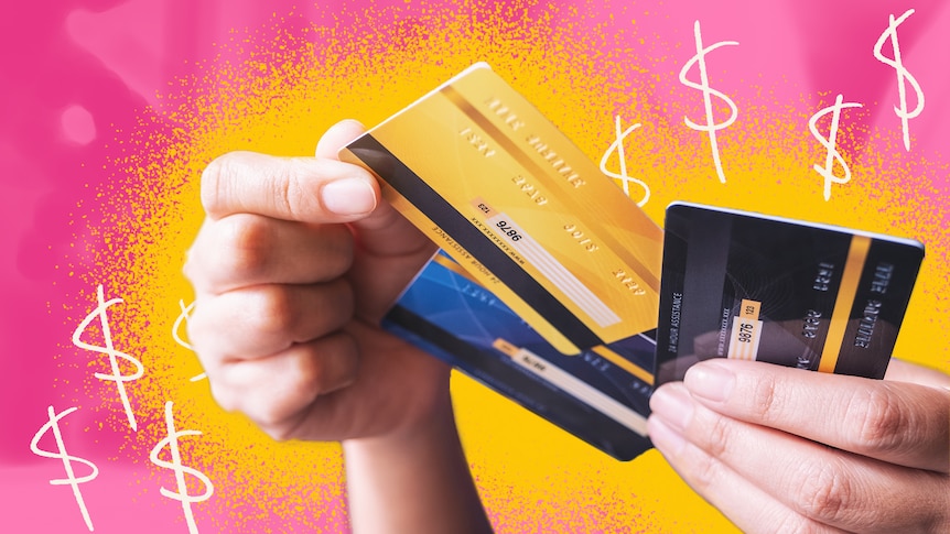 A woman holds three bank cards in her hands. The pink and yellow background is illustrated with dollar signs.