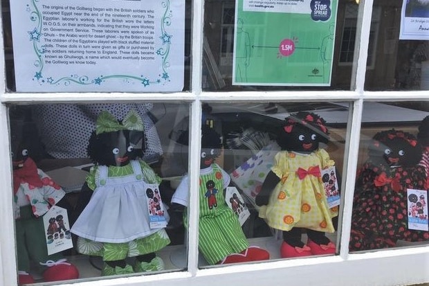 Golliwogs on display in shopfront window.