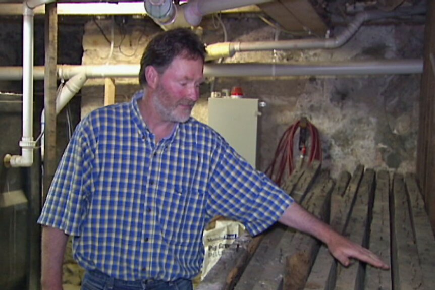Bank Arcade owner John Short with timbers he believes are from the original 1808 building.