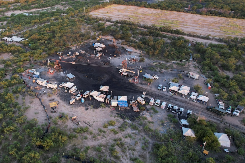 An overhead view of the mine site showing vehicles and infrastructure surrounding the site. 