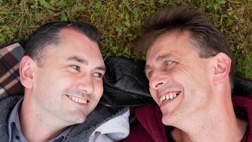 Close up photo of Jason Bartilotta [left] and Martin Baldock smiling at each other
