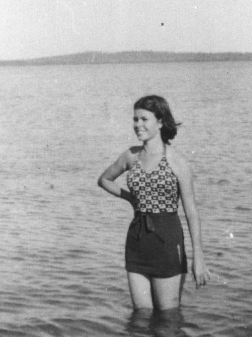 Madge Gaden wading in water at Channel Island.