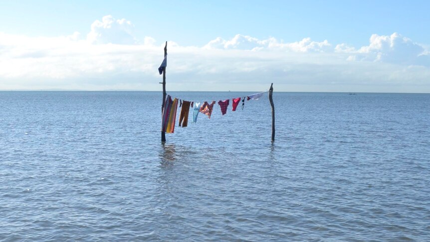 A line of washing sits in the shallows of Moreton Bay at Sandgate.