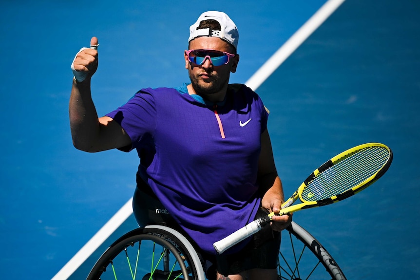 Dylan Alcott gives the thumbs up after winning a match at the Australian Open.