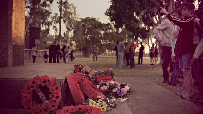 Wreaths lie at the Cenotaph during the Anzac Day dawn service in Mount Isa.