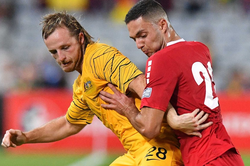 Rhyan Grant competes for possession against Bassel Jradi during a friendly match between Australia and Lebanon