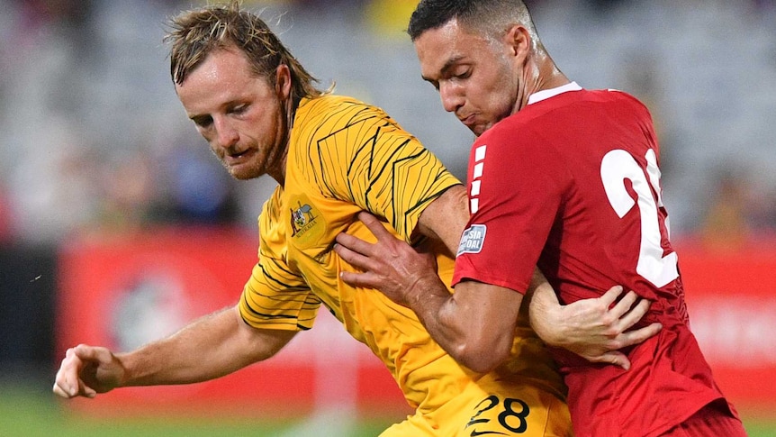 Rhyan Grant competes for possession against Bassel Jradi during a friendly match between Australia and Lebanon