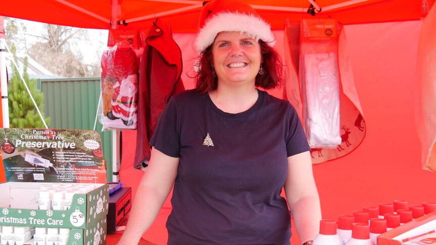 Katrina Fraser wearing Santa hat in red marque at Granite Belt Christmas farm