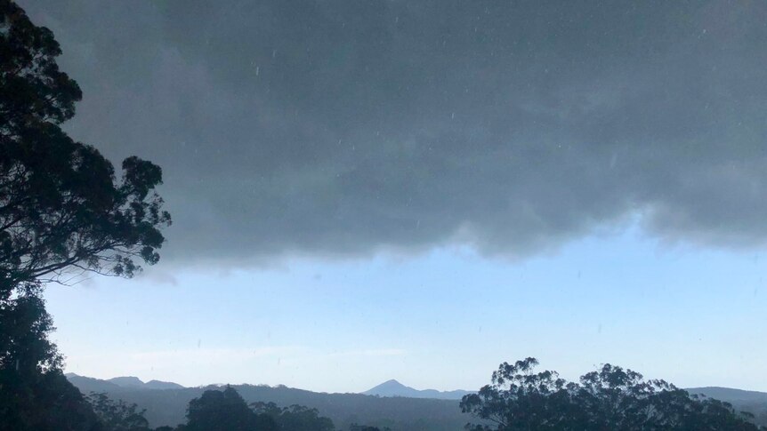 dark storm clouds approach cooroy mountain in the sunshine coast.