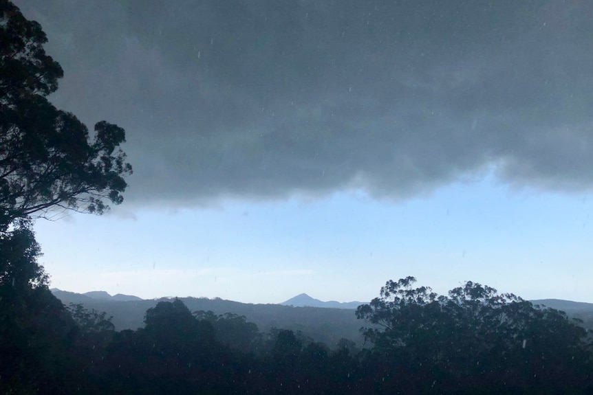 dark storm clouds approach cooroy mountain in the sunshine coast.