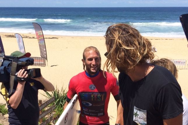 Owen Wright makes his way up the beach after taking out his heat at Merewether Beach.