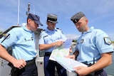 French maritime gendarmes look at a map