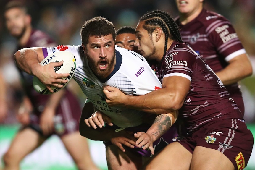 Kenny Bromwich tries to get an offload away in a tackle for the Storm against the Sea Eagles.