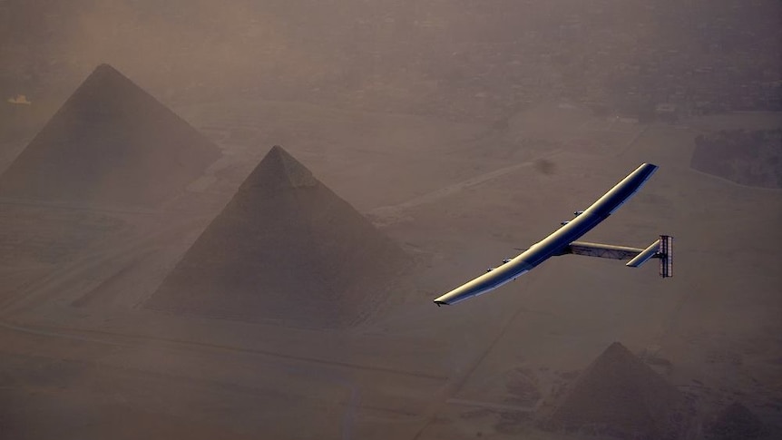 The Solar Impulse 2 flies over the Pyramids